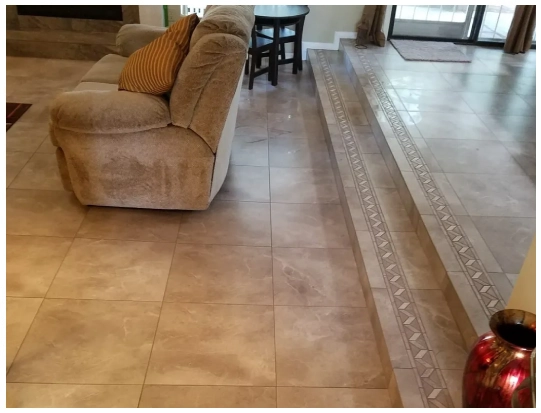 A living room with tile floors and carpet.