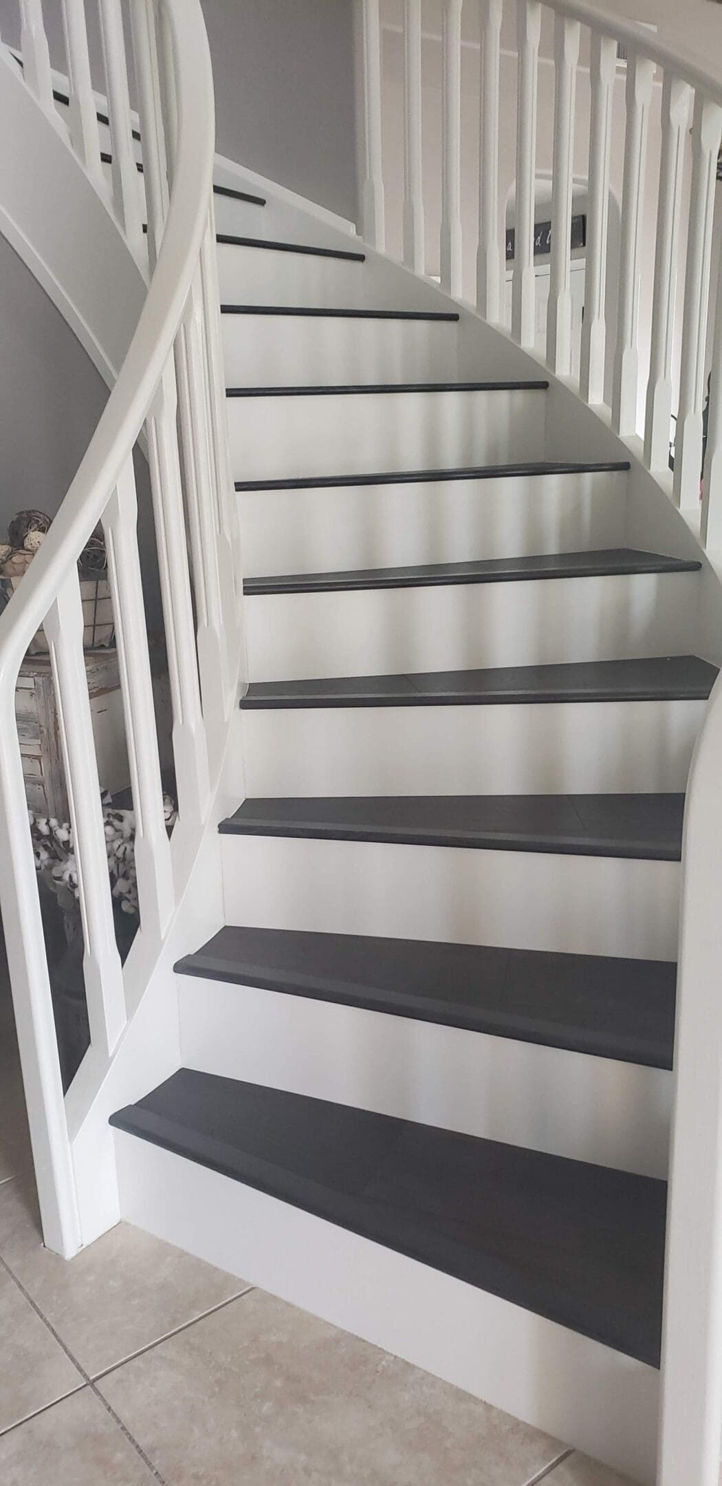 A staircase with white and grey steps painted in the same color.